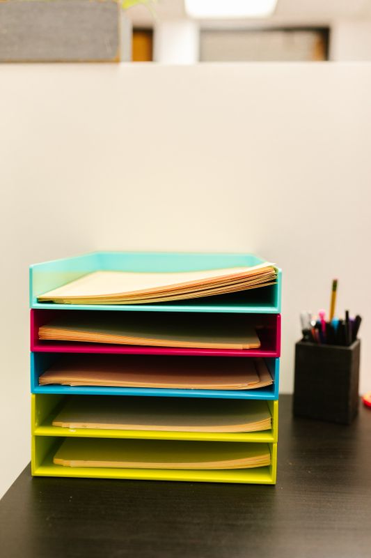 Paper trays of documents on an office desk